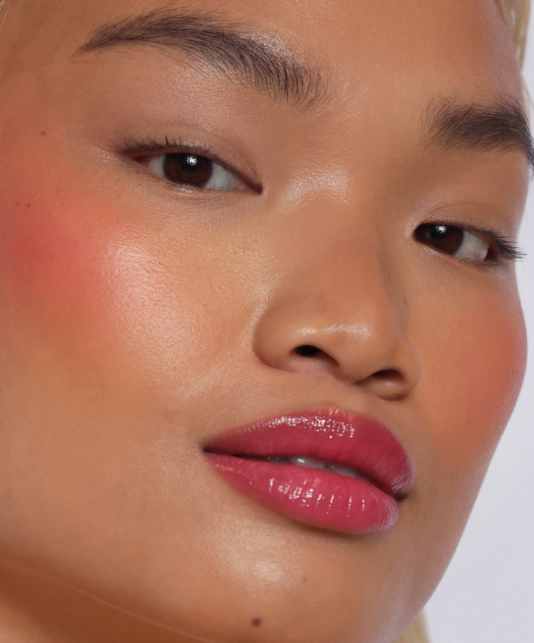 | desc: Ella wears Lip Gloss in shade Guava